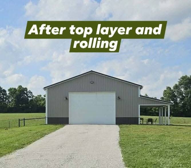 Finished gravel driveway leading up to a pole barn